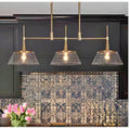 Quoridan 3-Light Brass Linear Island Chandelier with Seeded Glass Shades